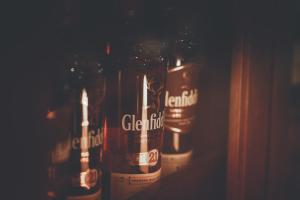 a row of beer bottles sitting on a shelf at Chrielka Hotel in Limassol
