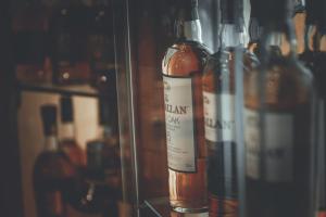 a group of bottles of wine on a shelf at Chrielka Hotel in Limassol