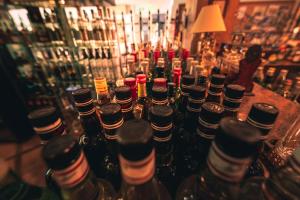 a group of bottles of alcohol sitting on a bar at Chrielka Hotel in Limassol
