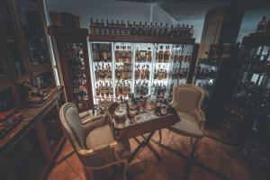 a bar with two chairs and a table with drinks at Chrielka Hotel in Limassol