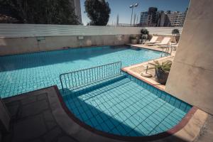 a large swimming pool with blue tiles on it at Chrielka Hotel in Limassol