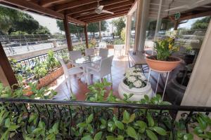a balcony with a table and chairs and plants at Chrielka Hotel in Limassol