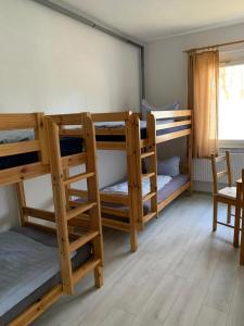 a room with three bunk beds and a window at Tauchbasis Stechlin in Stechlin