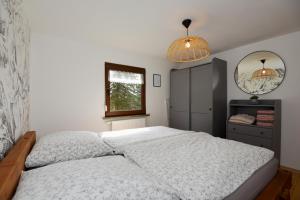a bedroom with a bed and two pendant lights at Bungalow im Thüringer Wald/ Haus Selma in Suhl