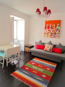 a living room with a couch and a table at Shabby Chic Bairro Alto in Lisbon