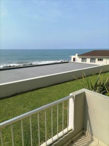 a view of the beach from the balcony of a house at OCEAN GARDENS 5 in Margate