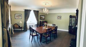 a dining room with a wooden table and chairs at Entire Farmhouse in Tipperary in Nenagh