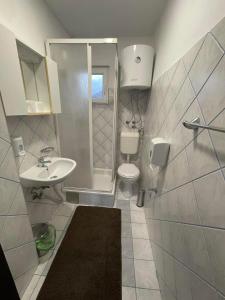 a bathroom with a sink and a toilet at Montana Apartmani in Konjic +38 photos