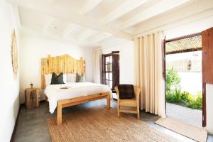 a bedroom with a large bed and a large window at Gonana Guesthouse in Paternoster