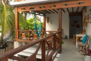 a wooden stairway leading to a patio with umbrellas at Quatro palos in Rincón