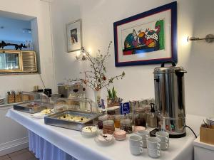 a table with cups and dishes on it at Waldwerk Wurlgrund Lychen in Lychen