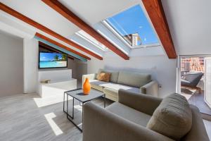 a living room with a couch and a tv at Villa Homa in Dubrovnik