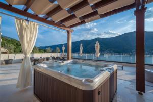 a jacuzzi tub in a house with a view at Boutique Hotel R Palazzo in Kotor