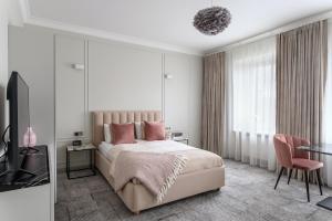 a bedroom with a large bed with pink pillows at Place No. 2 in Vilnius