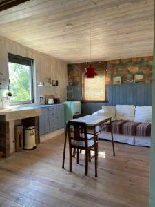 uma cozinha com uma mesa e uma cama num quarto em Cabana do Dinamarquês em Arga de Baixo em Arga de Baixo