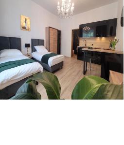 a bedroom with two beds and a desk and a sink at GOOD DAY APARTMENT centrum Katowice in Katowice