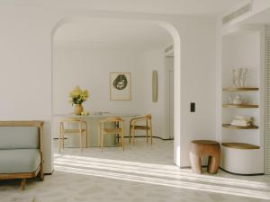 a living room with a couch and a table at Hôtel & Spa Belle Plage in Cannes