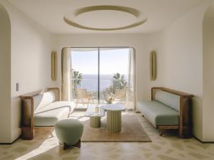 a living room with a view of the ocean at Hôtel & Spa Belle Plage in Cannes
