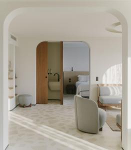 a bedroom with two beds and a mirror at Hôtel & Spa Belle Plage in Cannes