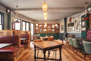 a restaurant with tables and chairs in a room at The Old Success Inn in Sennen Cove