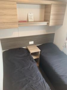 a bedroom with a bed and a desk and a bed sidx sidx sidx at CLJP Caravan Thorpe Park Cleethorpes Free WI-FI in Cleethorpes