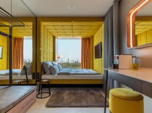 a room with a bed and a window at b'mine Hotel Frankfurt Airport in Frankfurt/Main