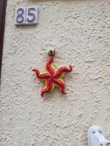 un pulpo rojo y amarillo al costado de un edificio en Appartamenti La Stella, en Castellammare del Golfo