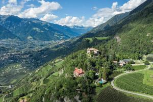 an aerial view of a village in the mountains at Relais & Chateaux Hotel Castel Fragsburg in Merano