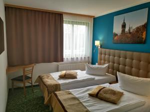 Postel nebo postele na pokoji v ubytování ACRON Hotel Wittenberg + 37 fotografií