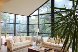 a living room with two couches and a large window at Cadgal - Tenuta La Cova in Calamandrana