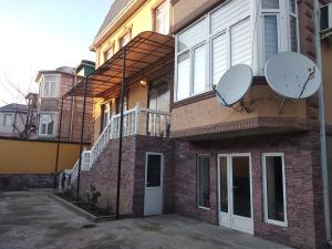 a building with two satellite dishes on the side of it at 3 floor quite cottage in Dushanbe in Dushanbe