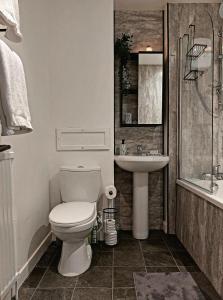 y baño con aseo y lavamanos. en Modern & Bright, G/F, 1BR APT. Real Hidden Gem en Hamilton