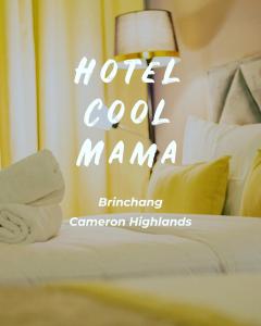 a hotel room with a bed with towels on it at Hotel COOL MAMA in Brinchang