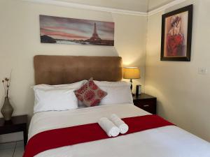 a bedroom with a bed with two towels on it at Fj's place in Durban