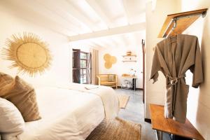 a bedroom with a bed and a dresser at Gonana Guesthouse in Paternoster