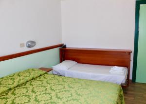Postel nebo postele na pokoji v ubytování Hotel Cristina