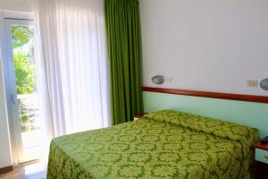 Postel nebo postele na pokoji v ubytování Hotel Cristina