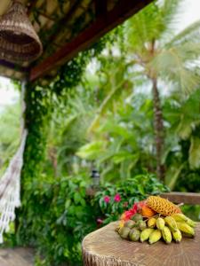 a pile of fruit sitting on a wooden table at Pousada Fasani in Ilha de Boipeba