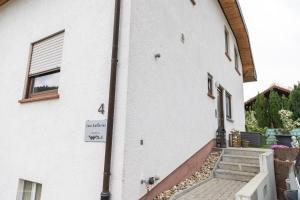 a white building with a staircase next to it at Casa Katharina in Wald-Michelbach