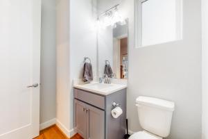 a bathroom with a sink and a toilet and a mirror at In the Heights in Houston
