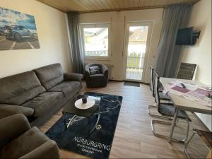 a living room with a couch and a table at Relaxen am Ring Fewo 2 in Wimbach
