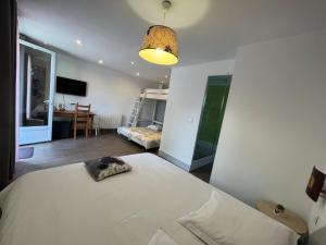 a bedroom with a bed and a room with a desk at Chambres d'Hôtes Poirier Bazin in Montry