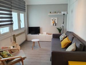a living room with a couch and a tv at AdA Apartamento in Santiago de Compostela