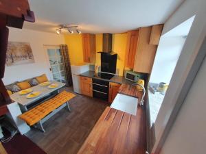 an overhead view of a kitchen with a table and a kitchen at Caudle Cottage, Ruardean in Lydbrook