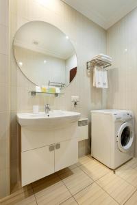 a bathroom with a sink and a washing machine at Greguar Hotel in Kyiv