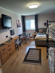 a bedroom with a bunk bed and a dining room at Pokoje, apartament NA WYSPIE in Sobieszewo