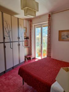a bedroom with a bed and a large window at Santa Ola in Levanto