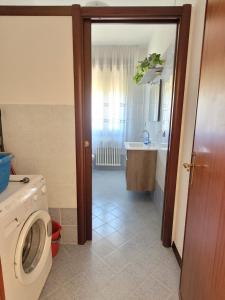 bagno con lavatrice e lavandino di Antonella's Home a Cavallino-Treporti