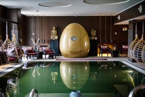 a hotel lobby with a pool and a room with furniture at Clarion Hotel Copenhagen Airport in Copenhagen
