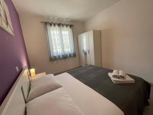 a bedroom with a large bed with towels on it at House Stojakovic in Banjol